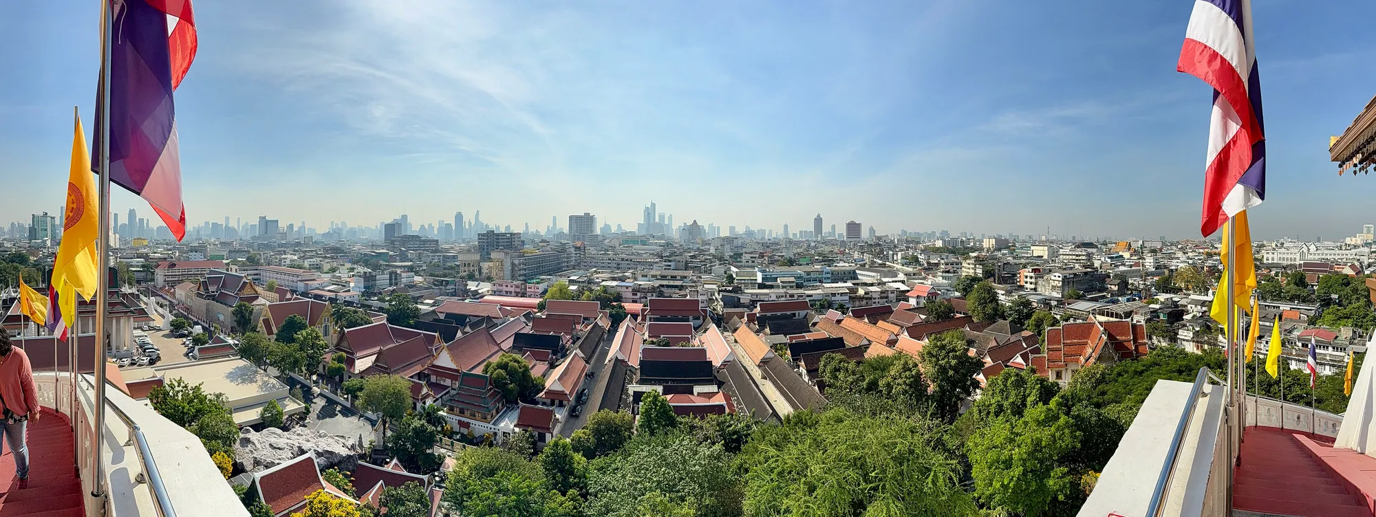 Bangkok from the Golden Mount at Wat Saket, with temple roofs in the foreground and the modern skyline behind