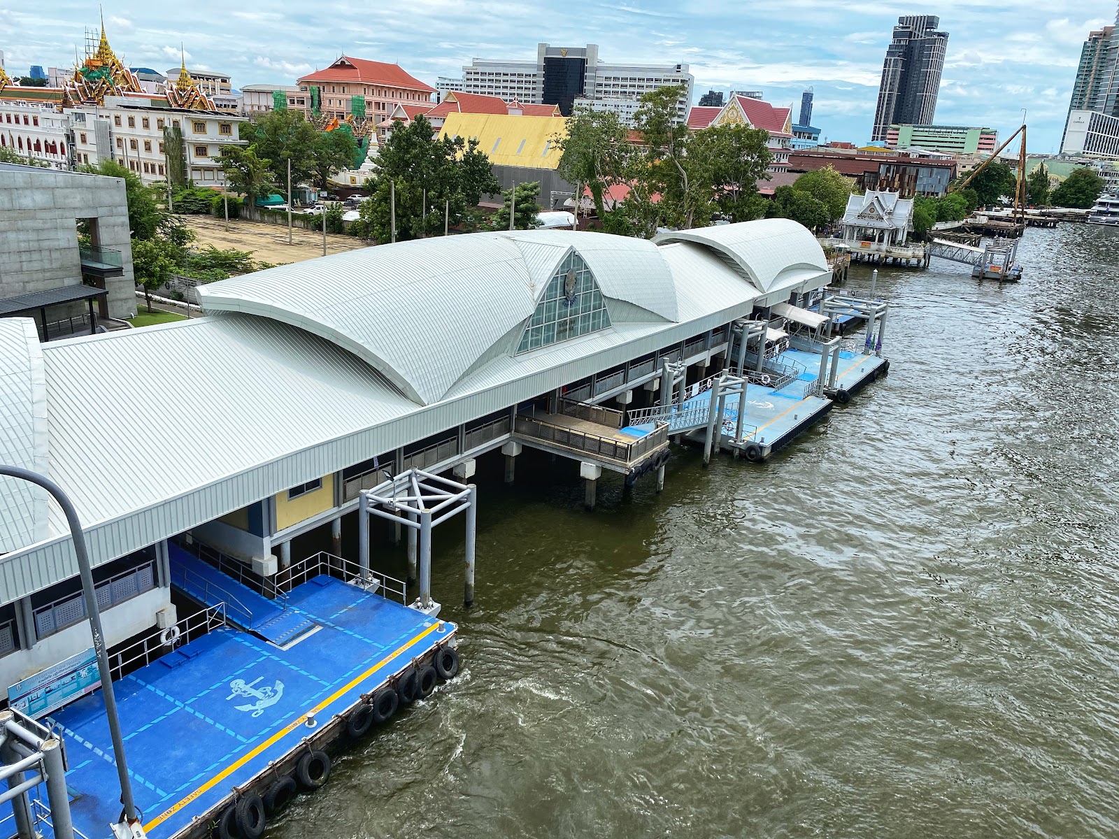 The covered Sathorn pier building and boat landing on the Chao Phraya River