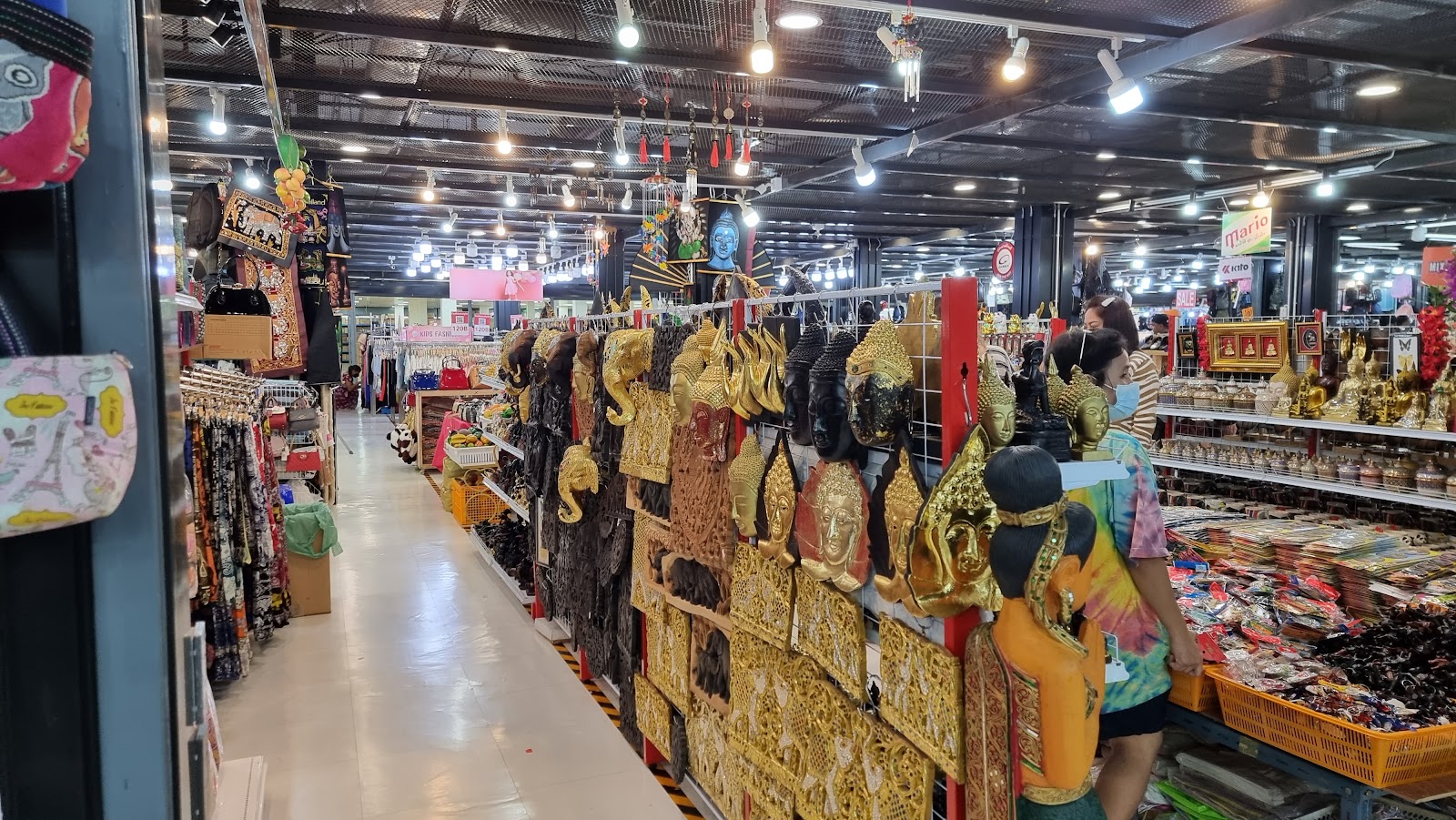 A long aisle of clothing and souvenir stalls inside Pratunam Market
