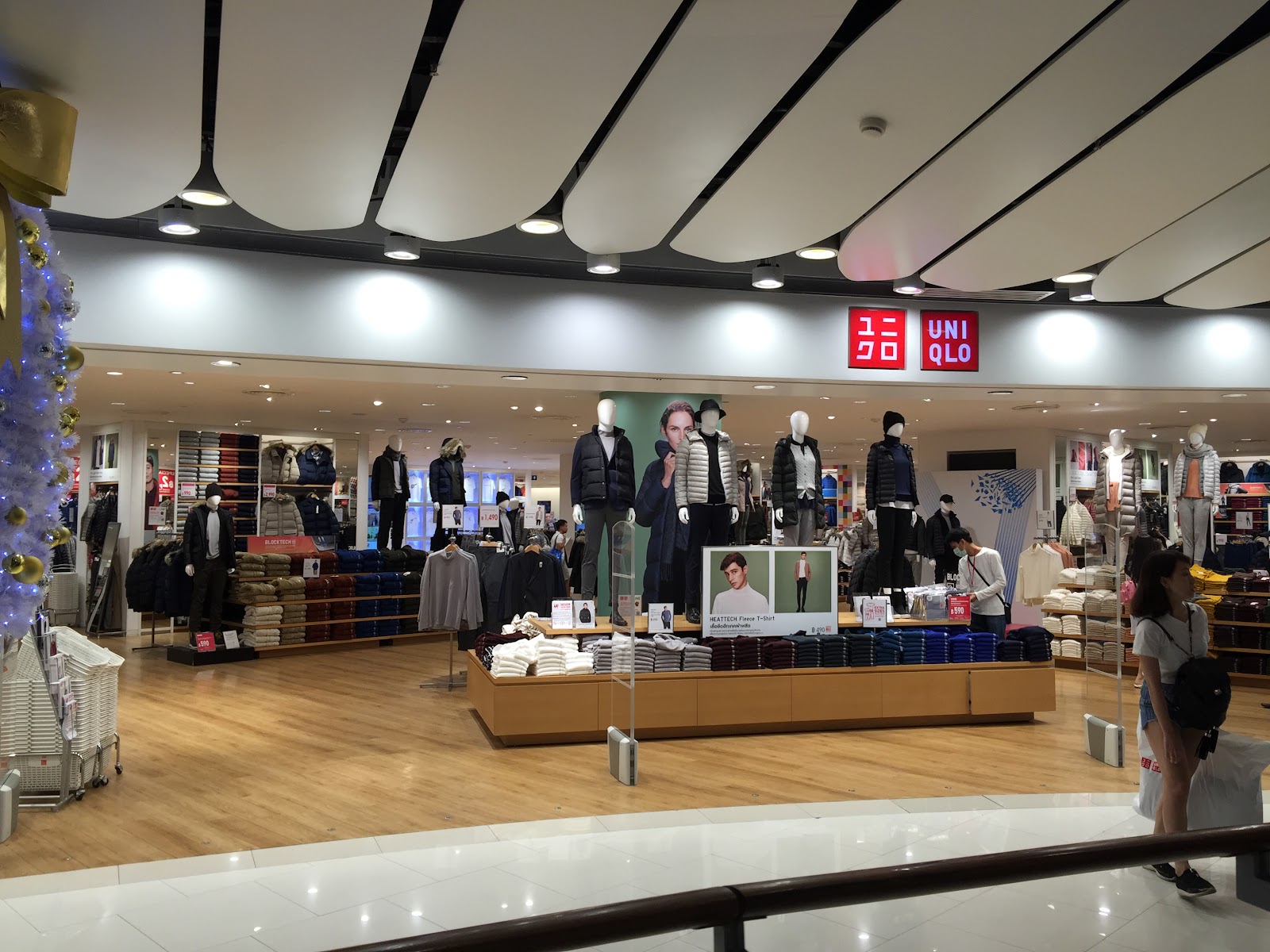 The open storefront of UNIQLO CentralWorld with racks of clothing and mannequins