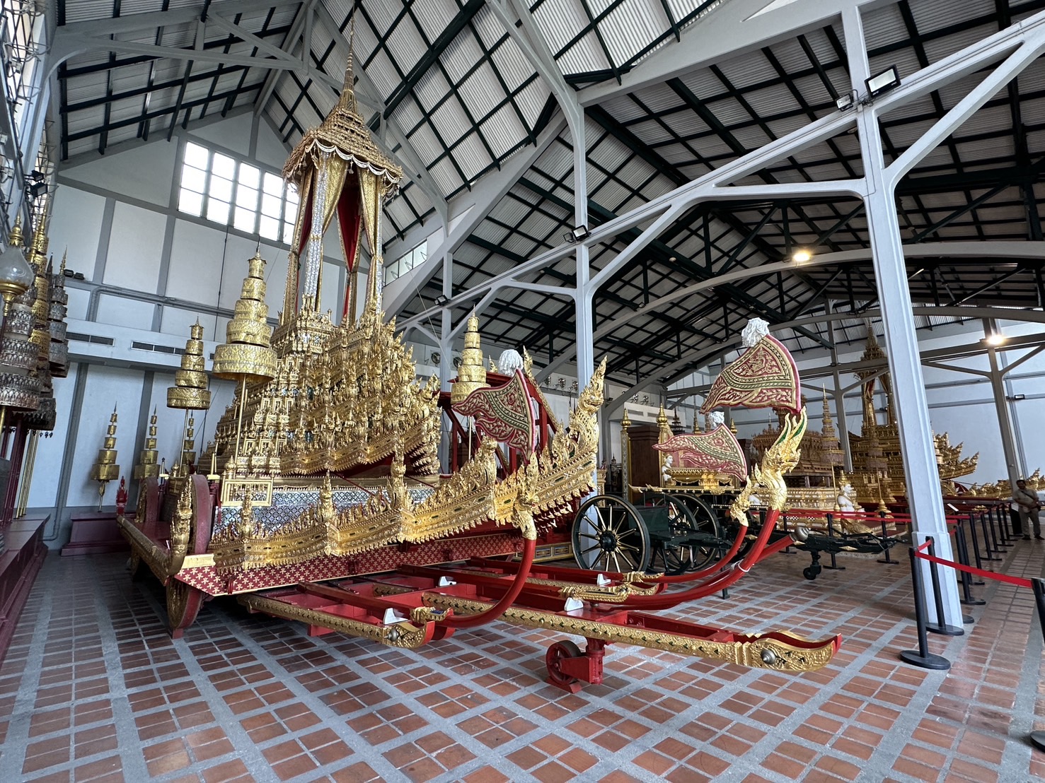 A large gilded chariot in a gallery at the National Museum Bangkok
