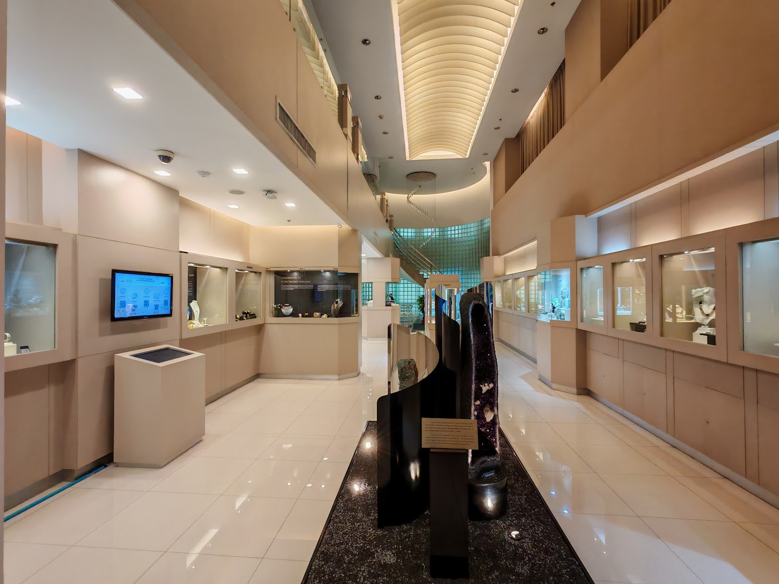Display cases lining a corridor inside the Gem and Jewelry Institute of Thailand