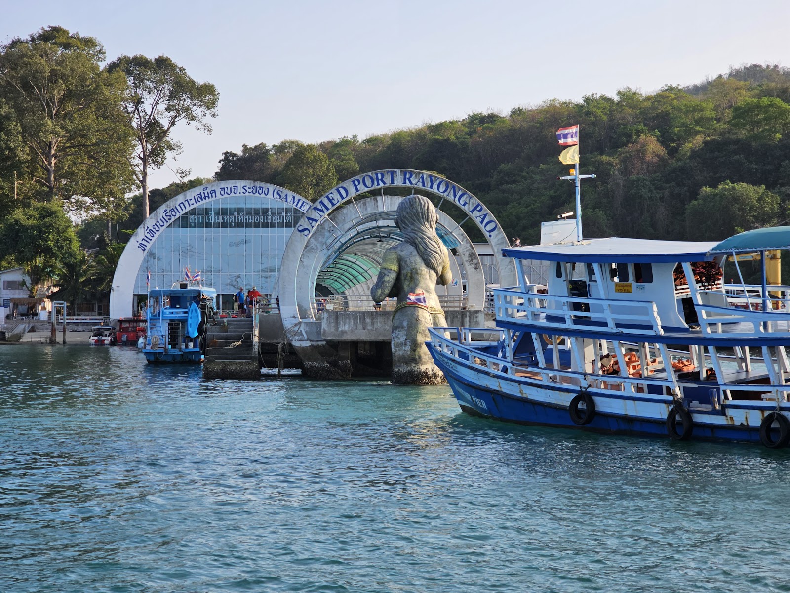 Passenger boats beside the arched terminal of Na Dan pier on Koh Samet