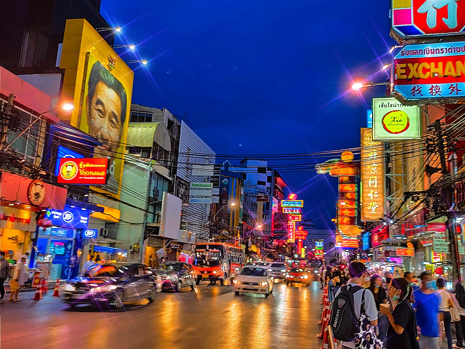 Yaowarat Road at night lined with illuminated Chinese shop signs