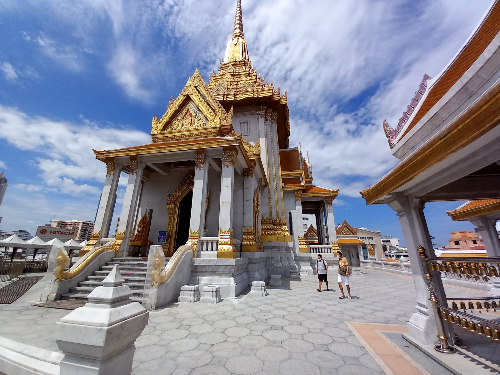 The white-and-gold hall of Wat Traimit with its tiered spire, seen from the terrace