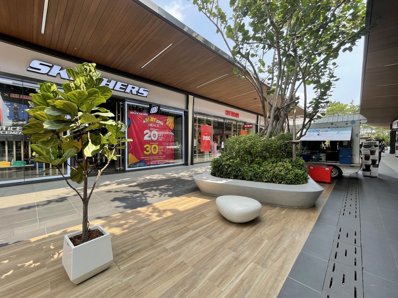 A shaded open-air walkway lined with shopfronts at Siam Premium Outlets Bangkok