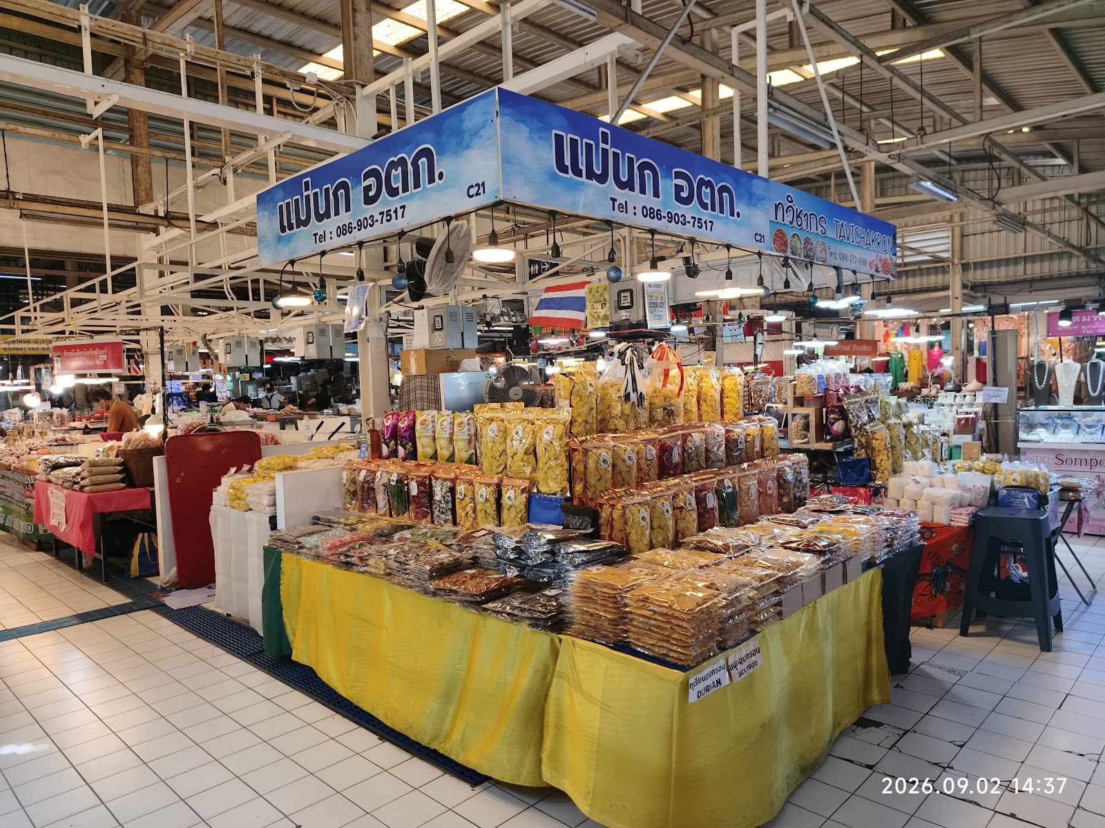 A market stall stacked with bags of dried fruit and snacks at Or Tor Kor Market