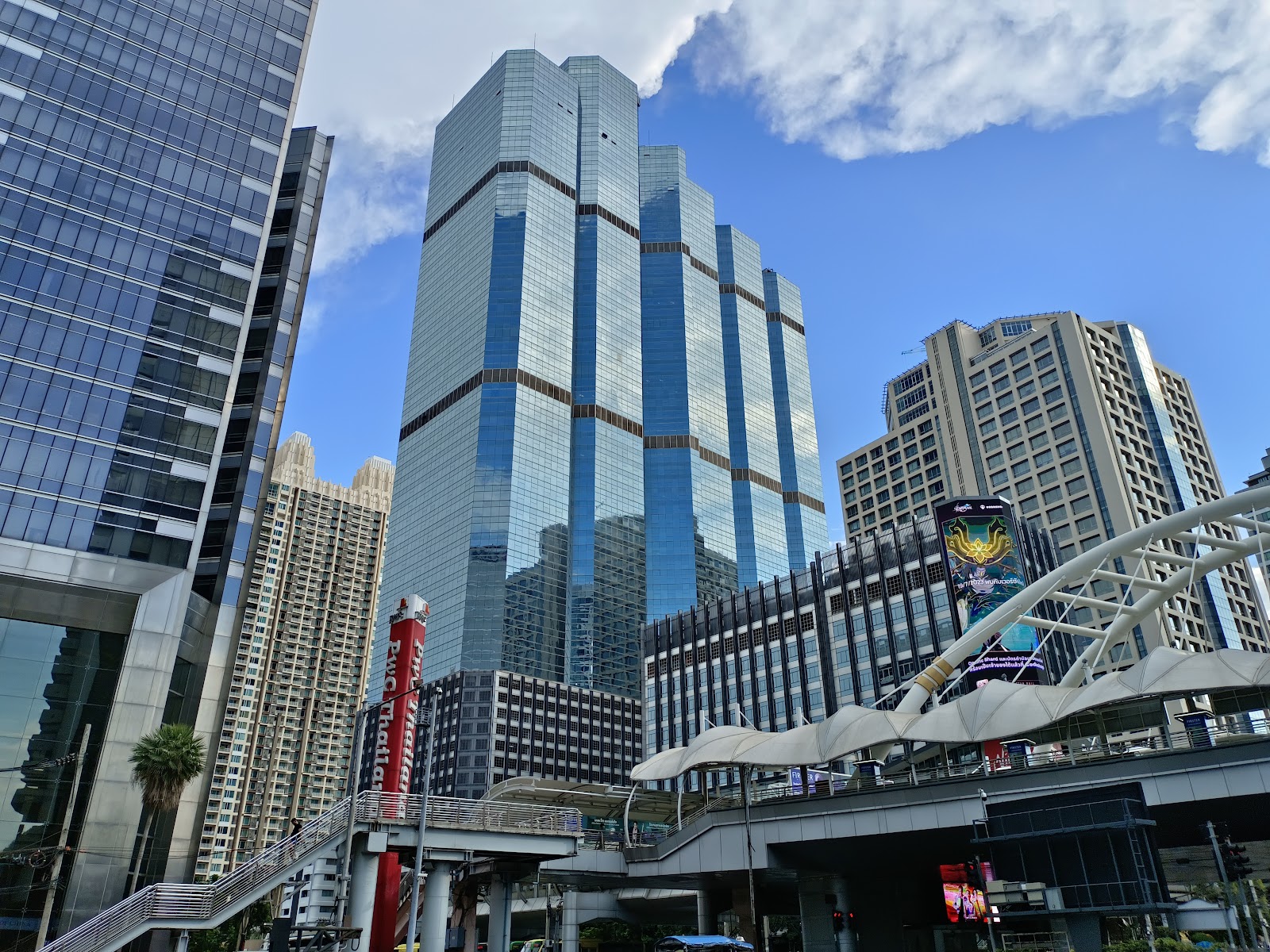 Glass office towers beside the elevated walkway at Chong Nonsi
