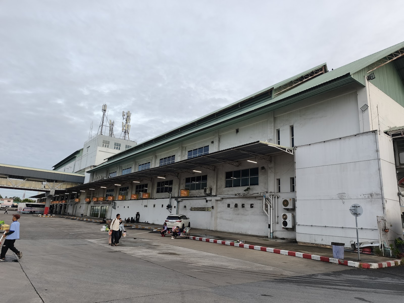 The long white terminal building of Bangkok's Southern Bus Terminal with its bus bays