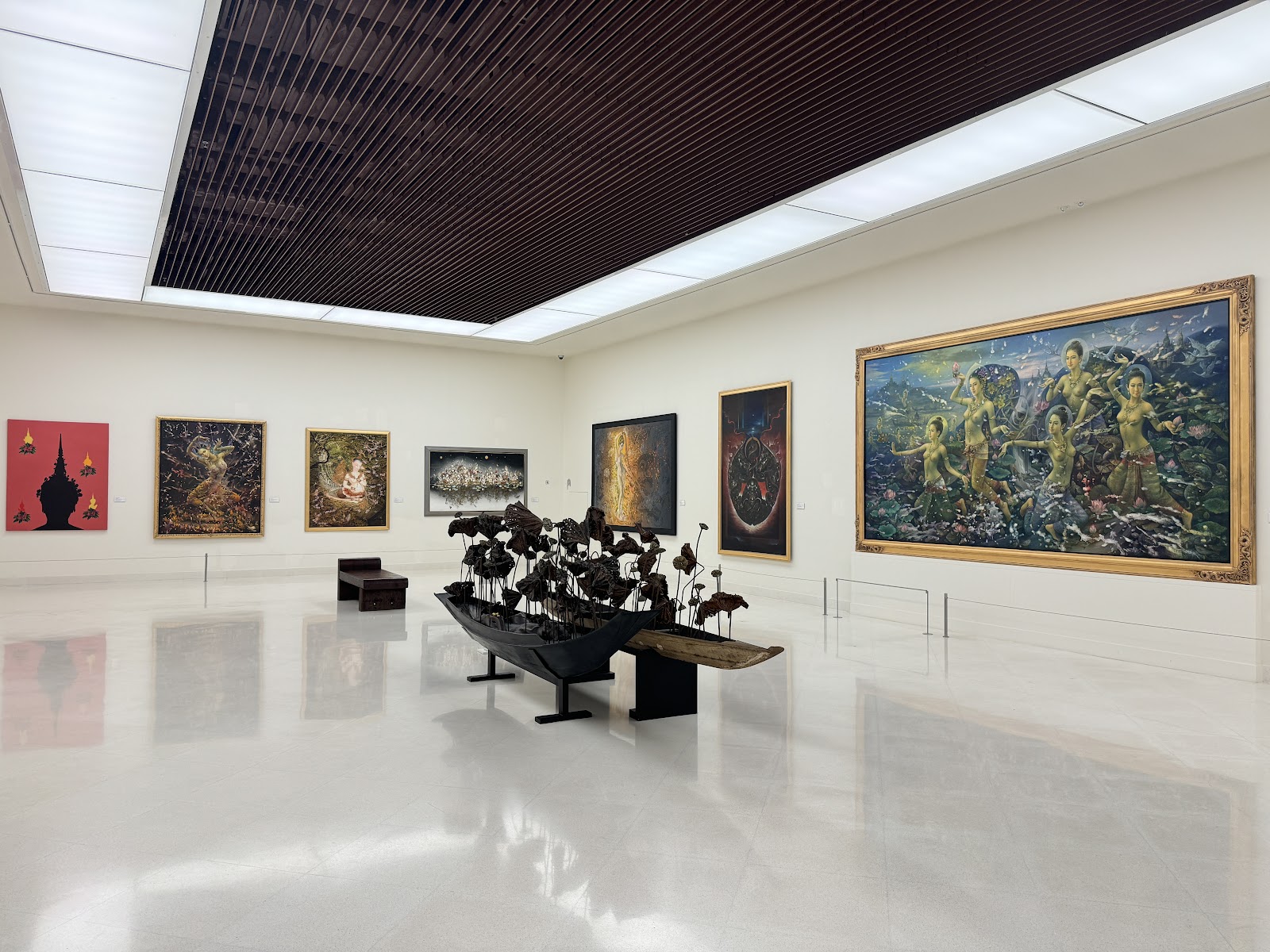 A bright gallery at MOCA Bangkok hung with large Thai paintings