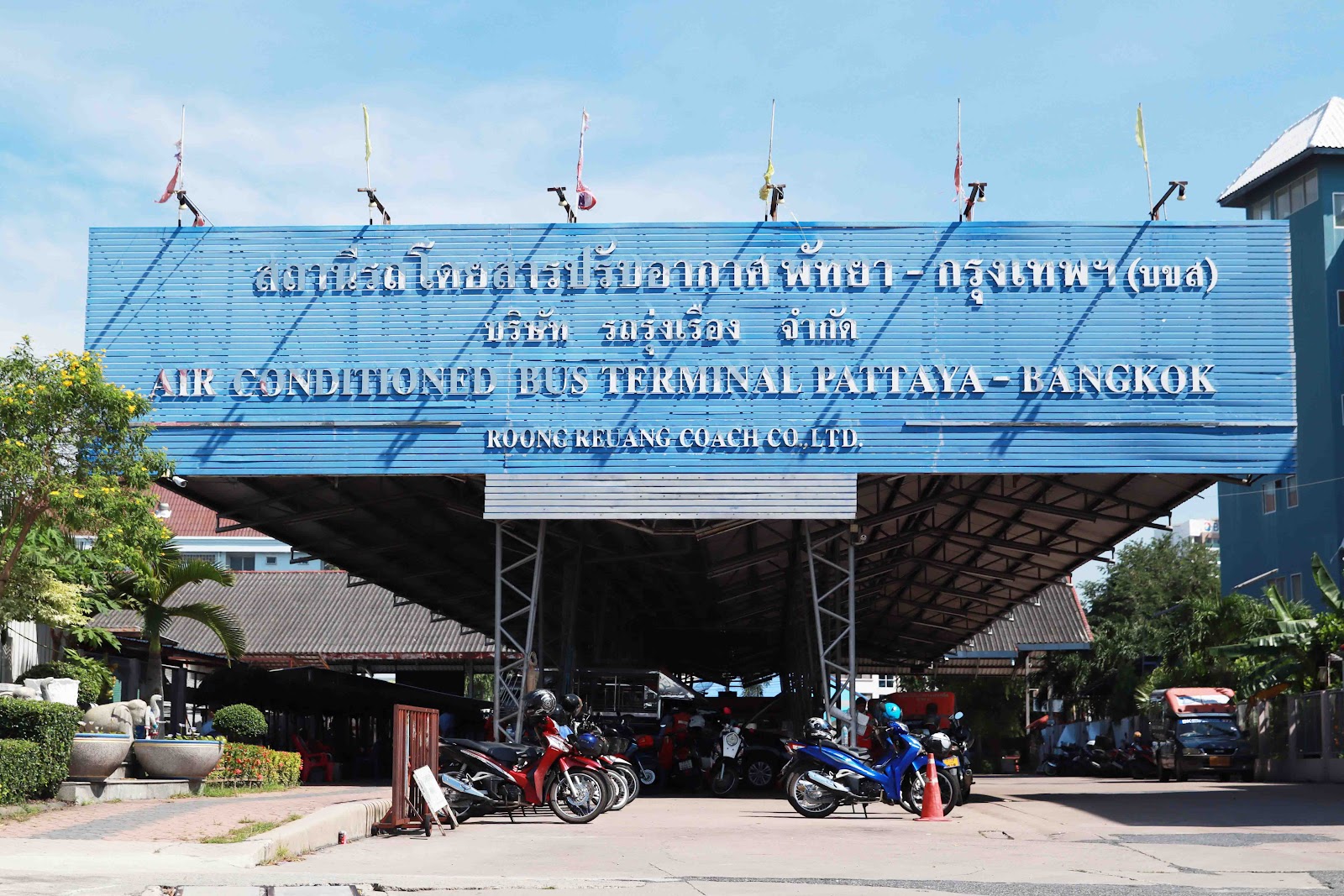 Blue sign over the entrance of the air-conditioned bus terminal for Pattaya to Bangkok coaches