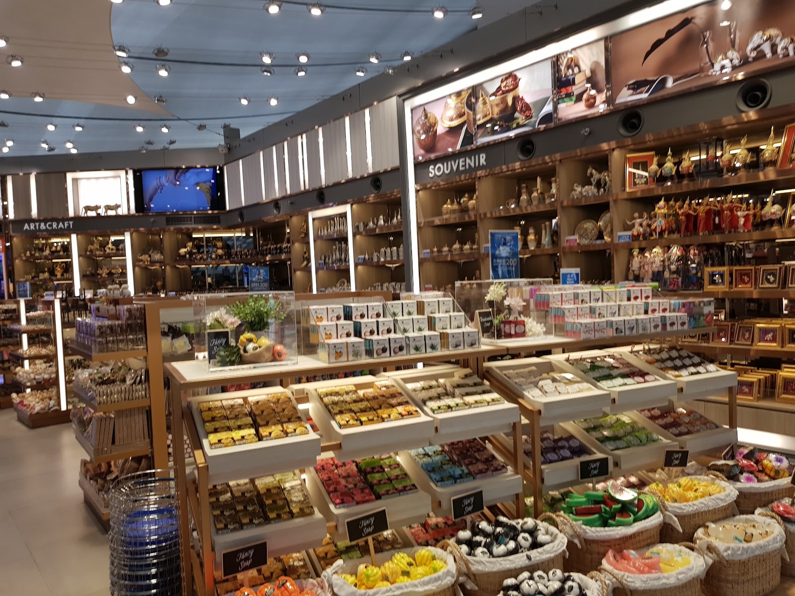 Shelves of packaged Thai snacks, dried fruit and souvenirs in a King Power store at Suvarnabhumi Airport