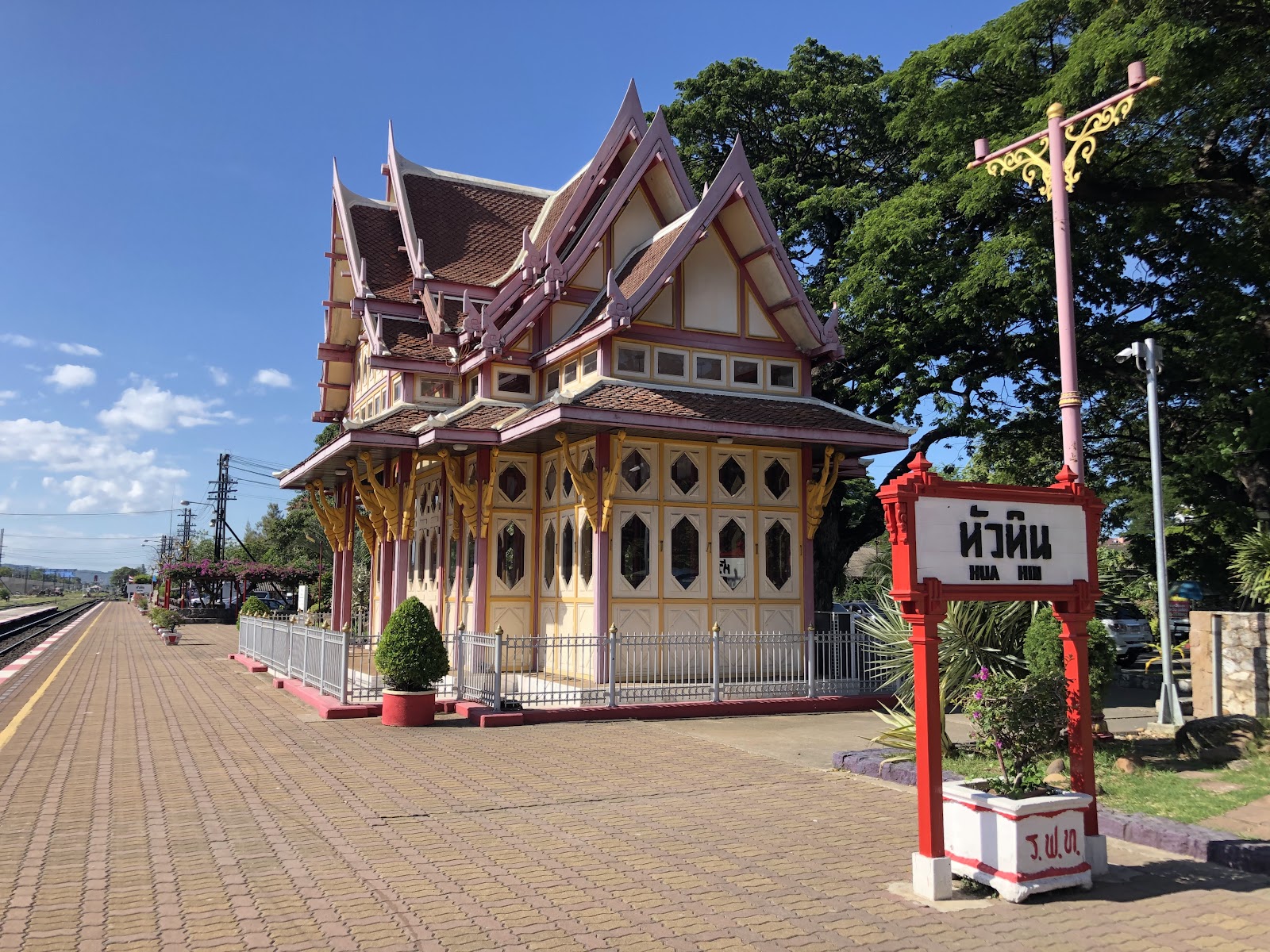 The ornate royal waiting pavilion and red Hua Hin station sign on the platform of Hua Hin railway station
