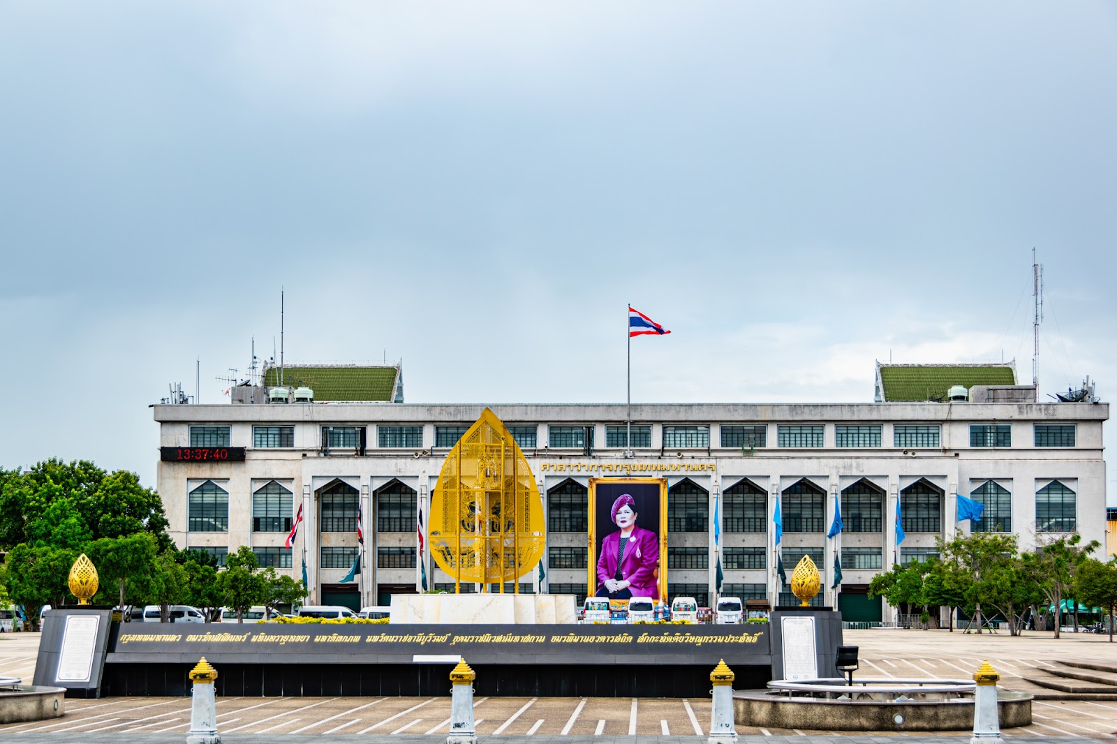 The long white facade of Bangkok City Hall behind its open forecourt