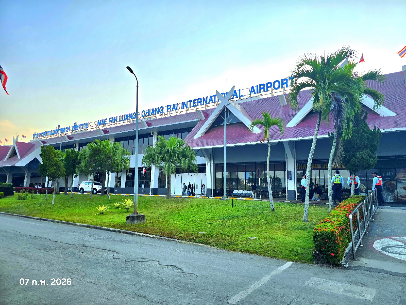 The terminal front of Mae Fah Luang-Chiang Rai International Airport with its Lanna-style roof and palm trees