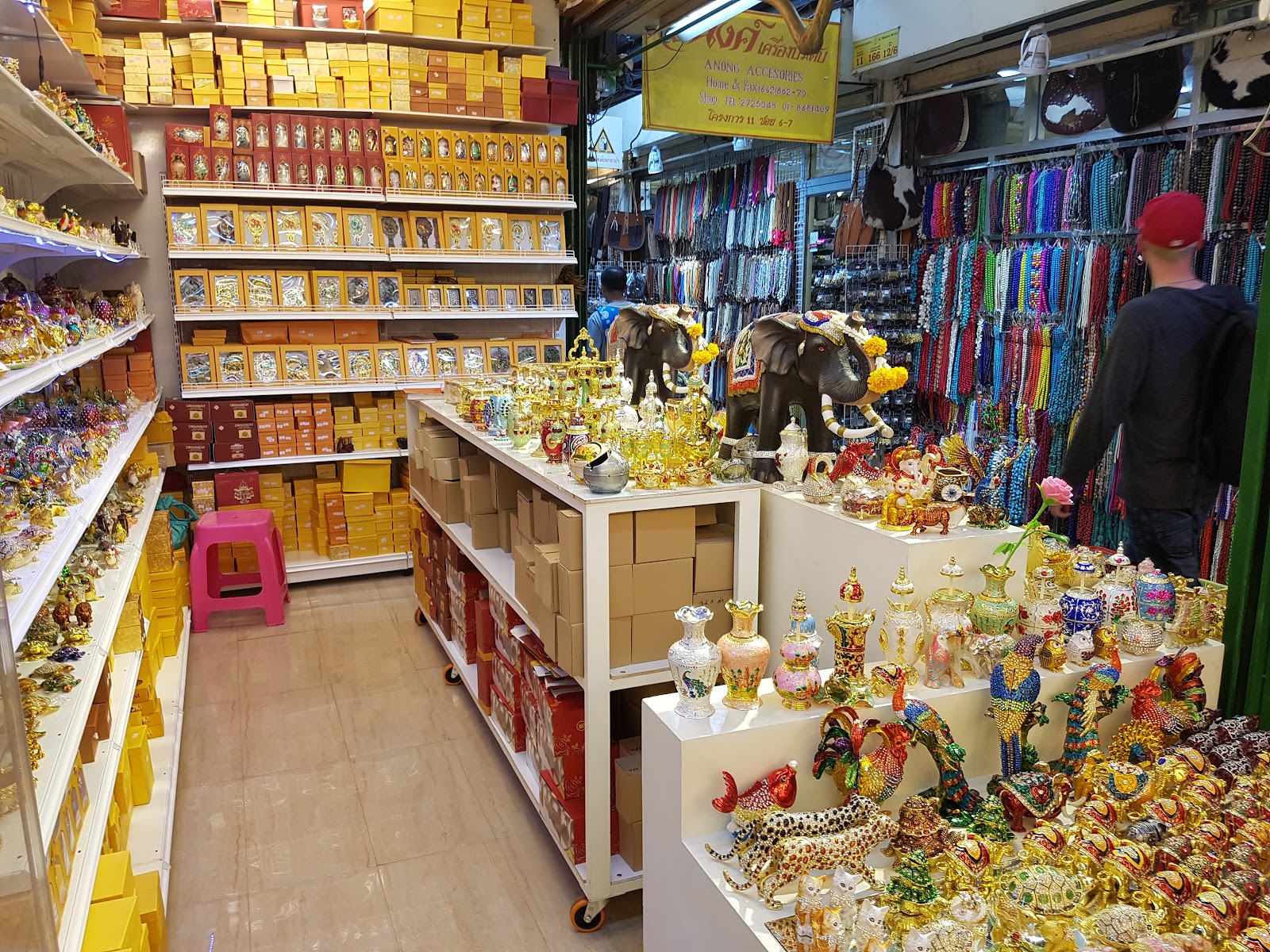 A Chatuchak Weekend Market shop stacked with souvenirs, scarves and elephant figurines
