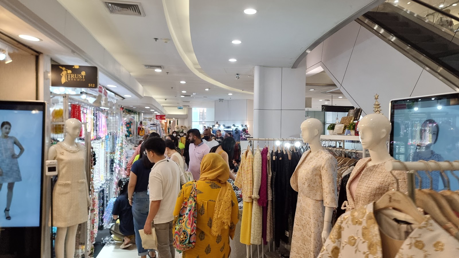 Racks of dresses and clothing shops along a corridor inside Platinum Fashion Mall