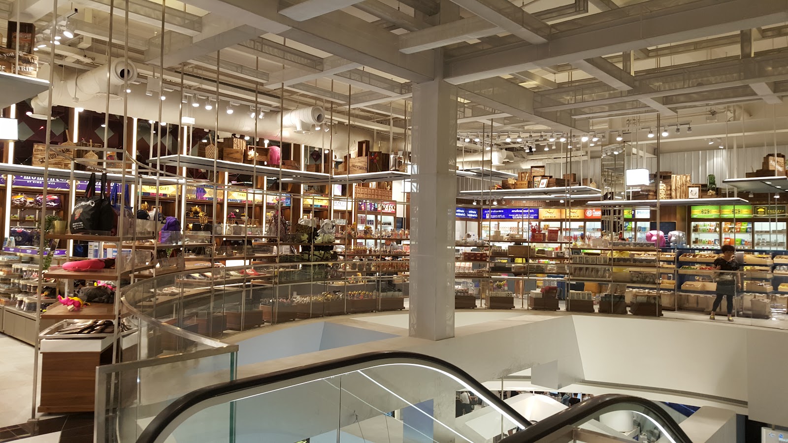 The multi-level shopping floor of King Power Rangnam with escalators and boutiques