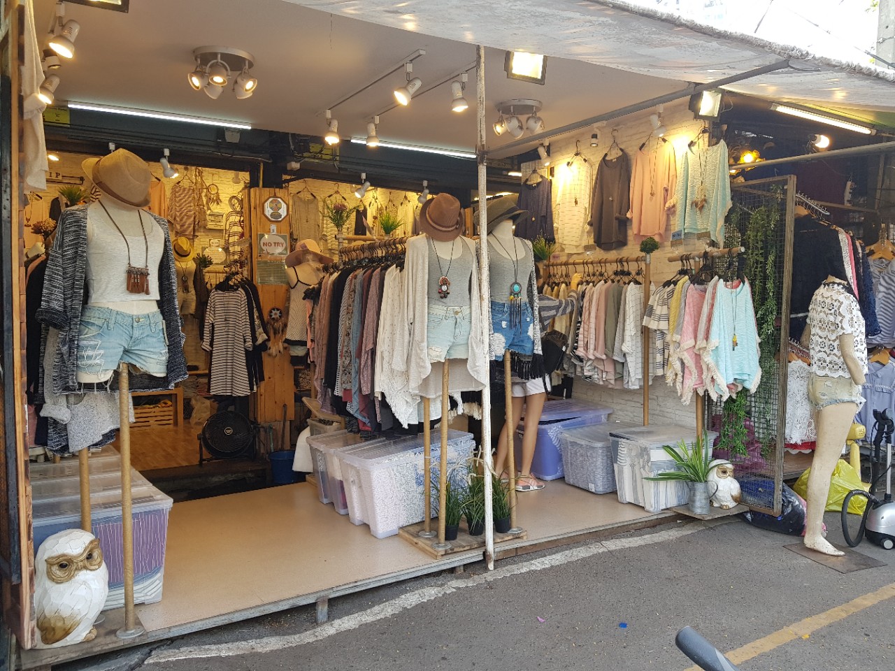 A clothing stall with racks and mannequins at Chatuchak Weekend Market