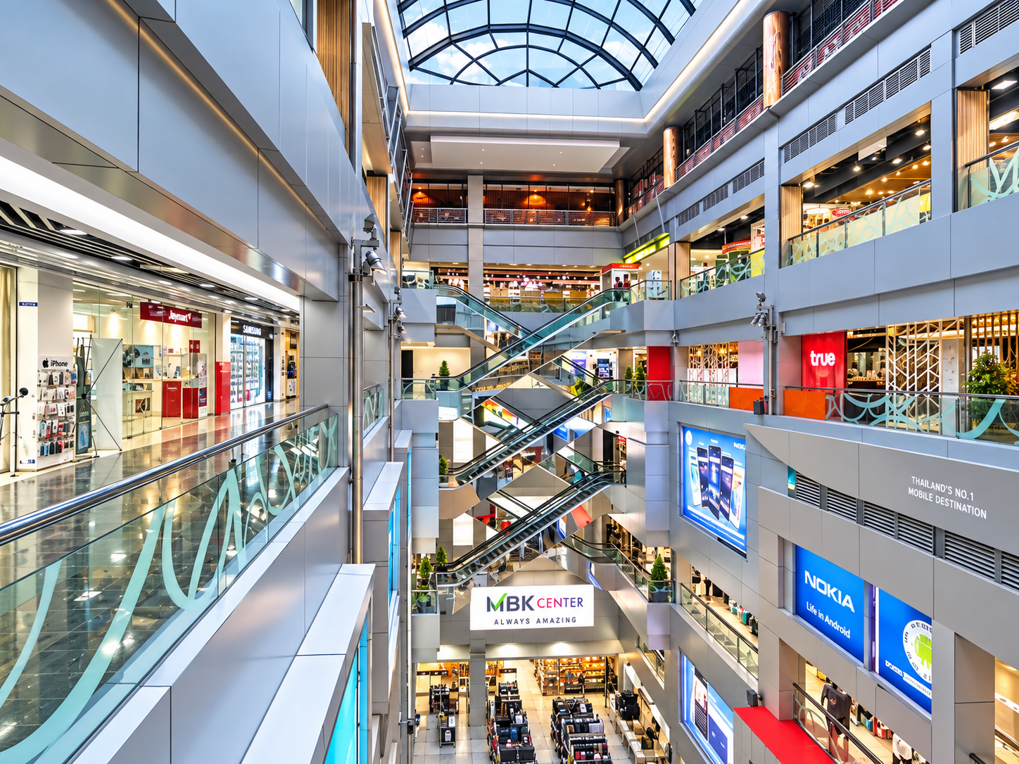 Looking up through the multi-level central atrium and escalators of MBK Center