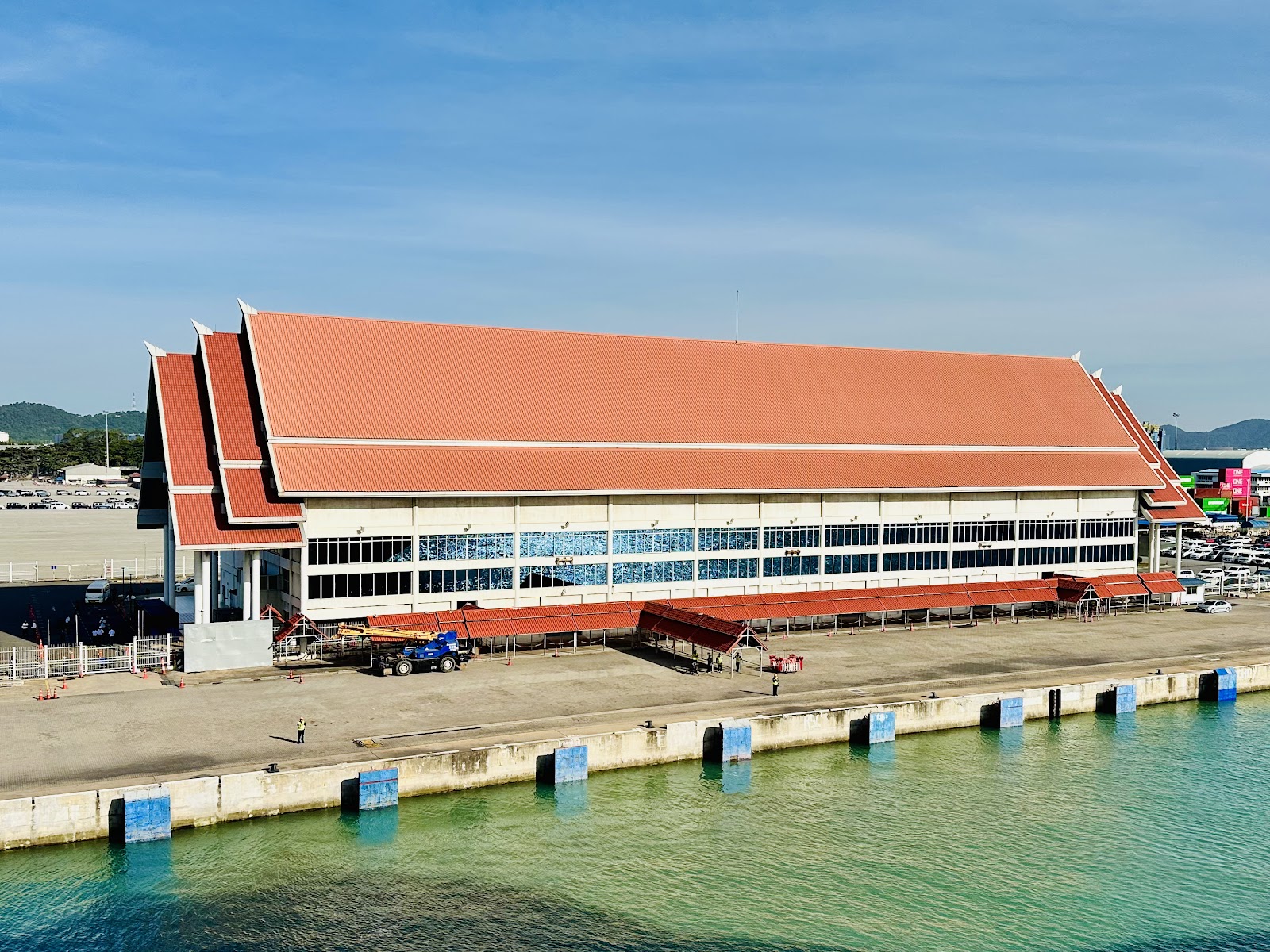 The red-roofed passenger terminal building on the quay at Laem Chabang