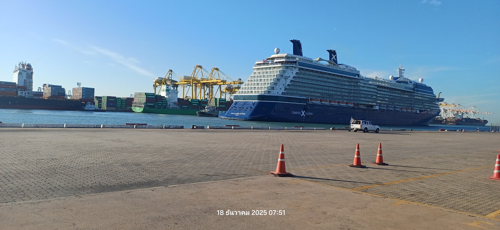 A cruise ship moored at Laem Chabang with container cranes in the background
