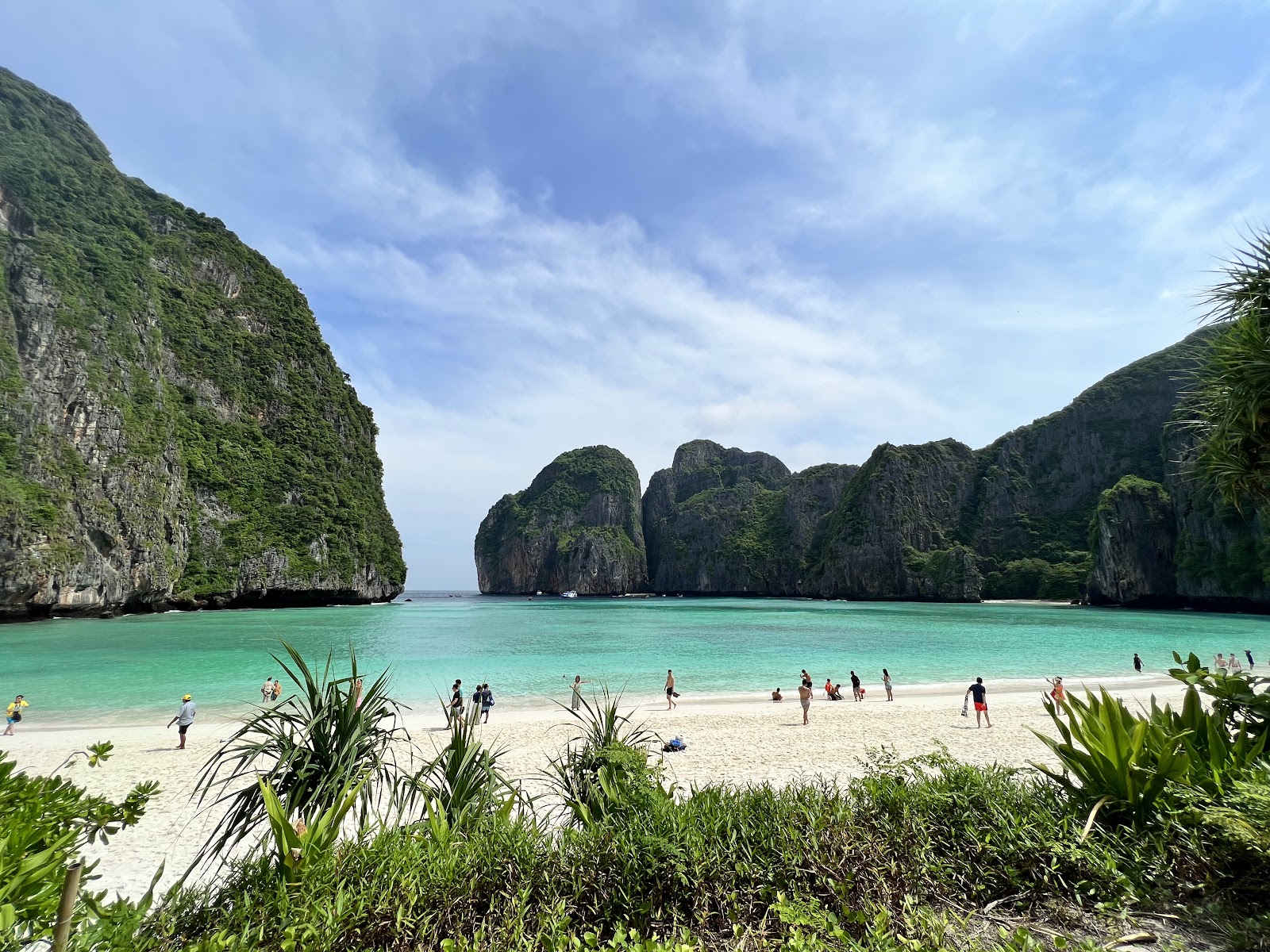 The white sand beach of Maya Bay framed by tall limestone cliffs