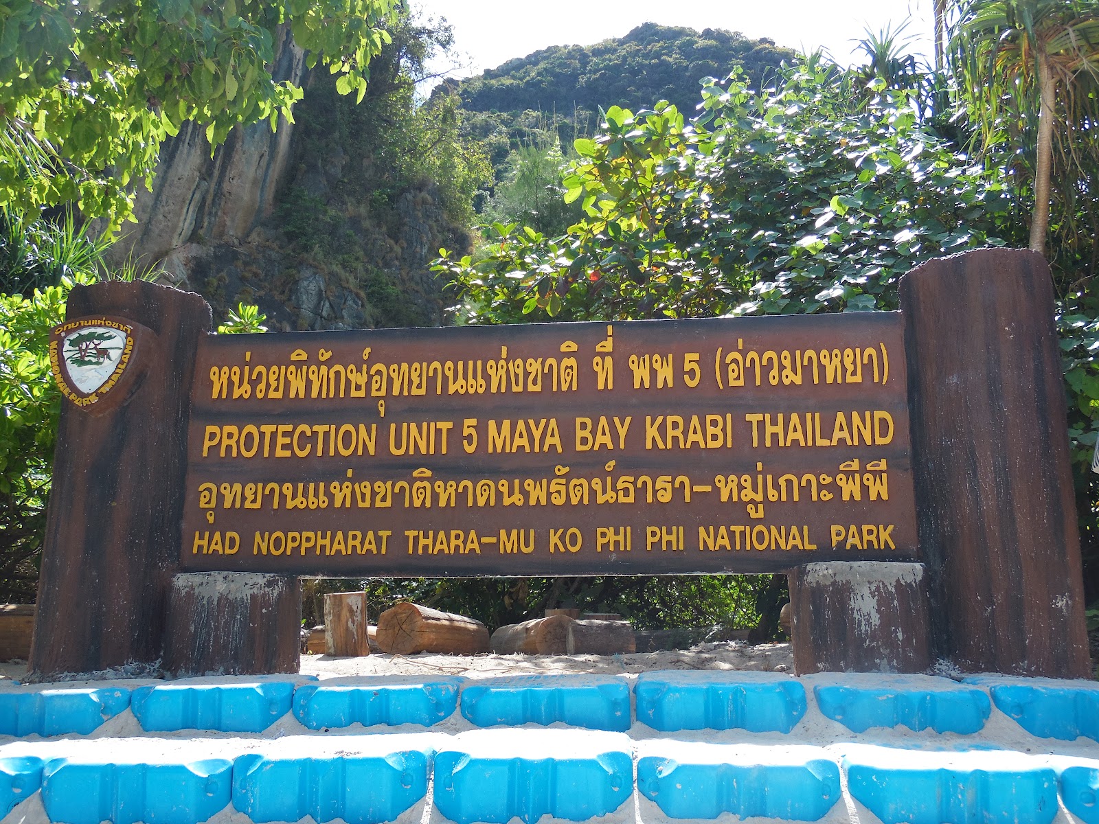 A carved wooden park sign reading Protection Unit 5 Maya Bay, Had Noppharat Thara-Mu Ko Phi Phi National Park