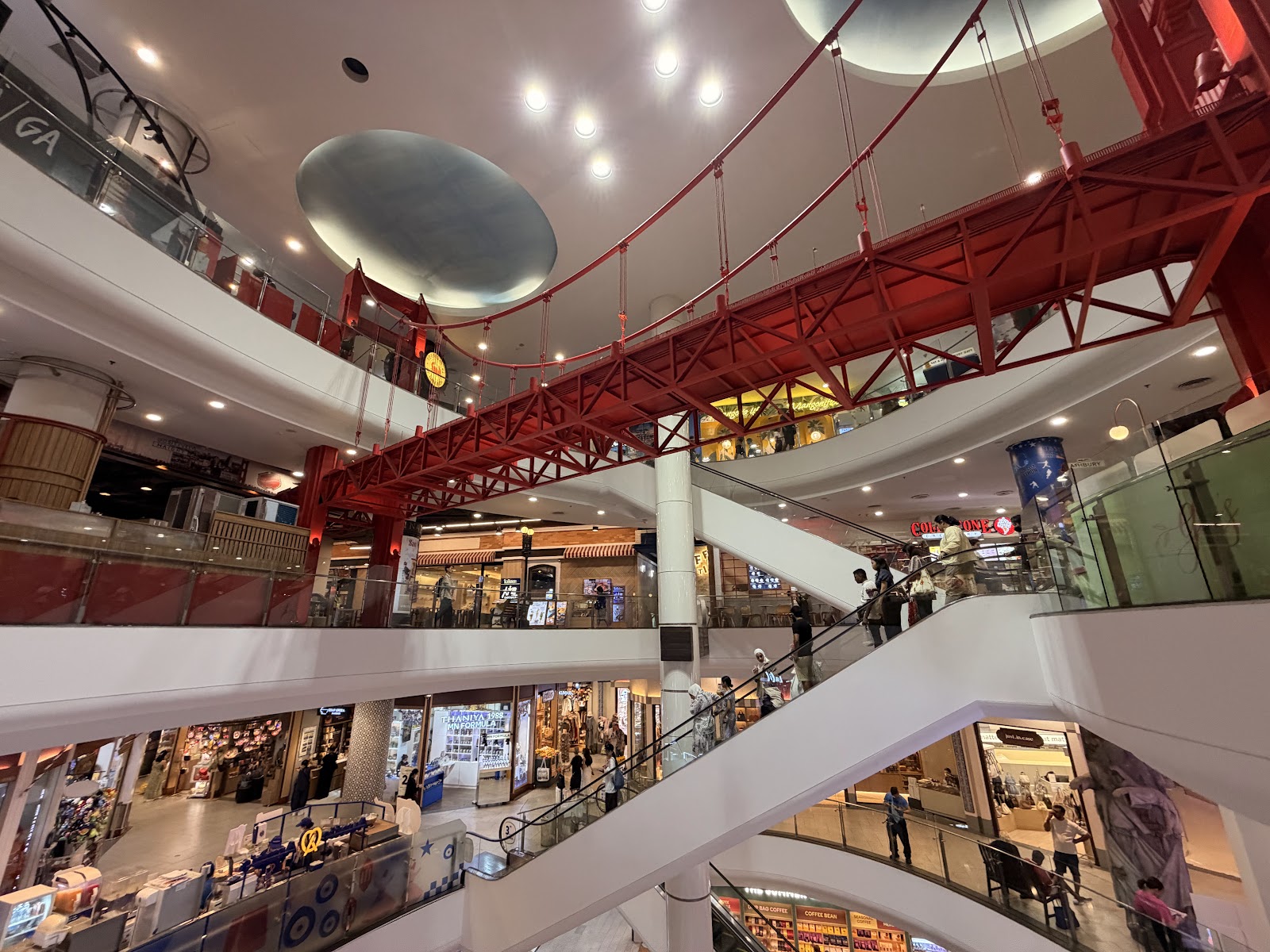 The atrium of Terminal 21 Asok with a red Golden Gate Bridge model spanning the upper floors