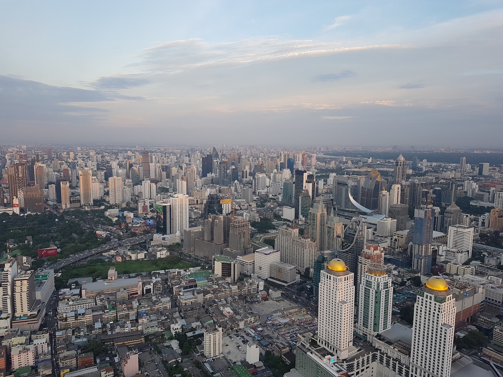 View over central Bangkok towers and low-rise neighborhoods from Baiyoke Tower II