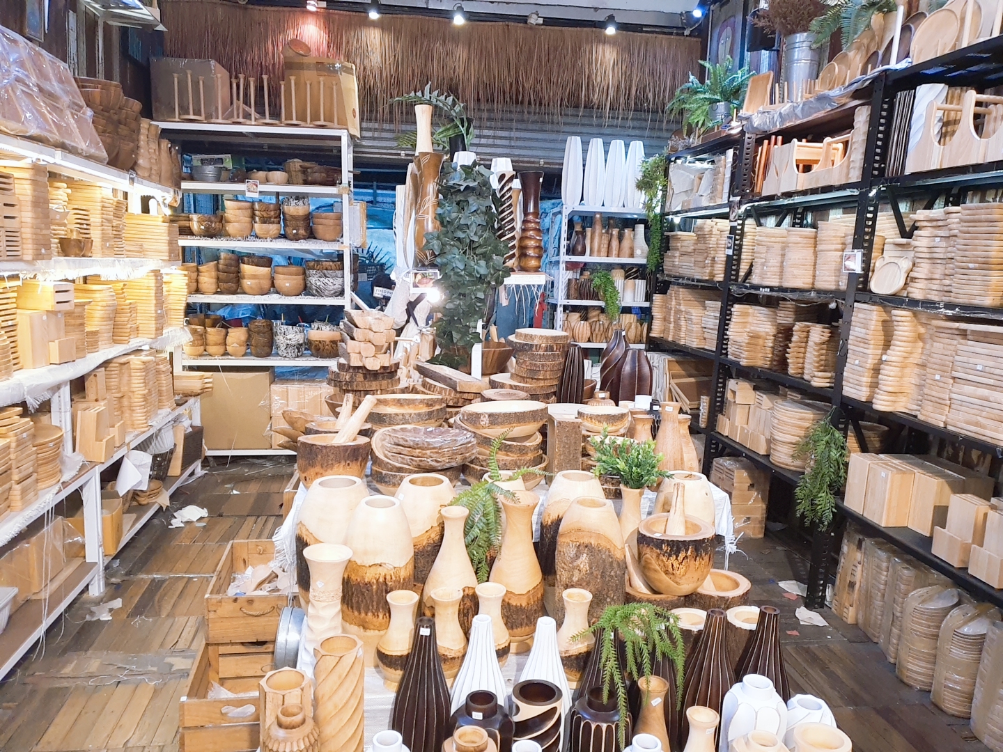 A Chatuchak Weekend Market shop stacked with wooden and ceramic homeware