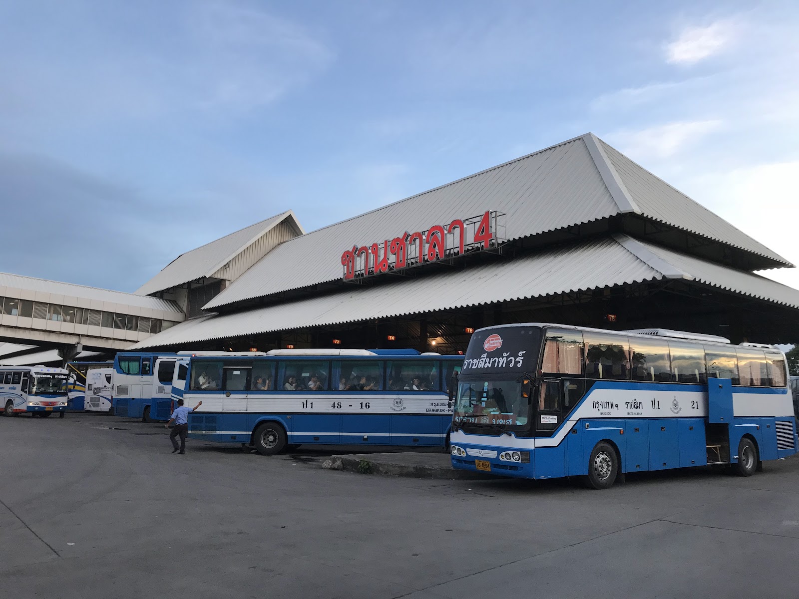 Blue and white intercity buses parked outside the Bangkok Bus Terminal in Chatuchak