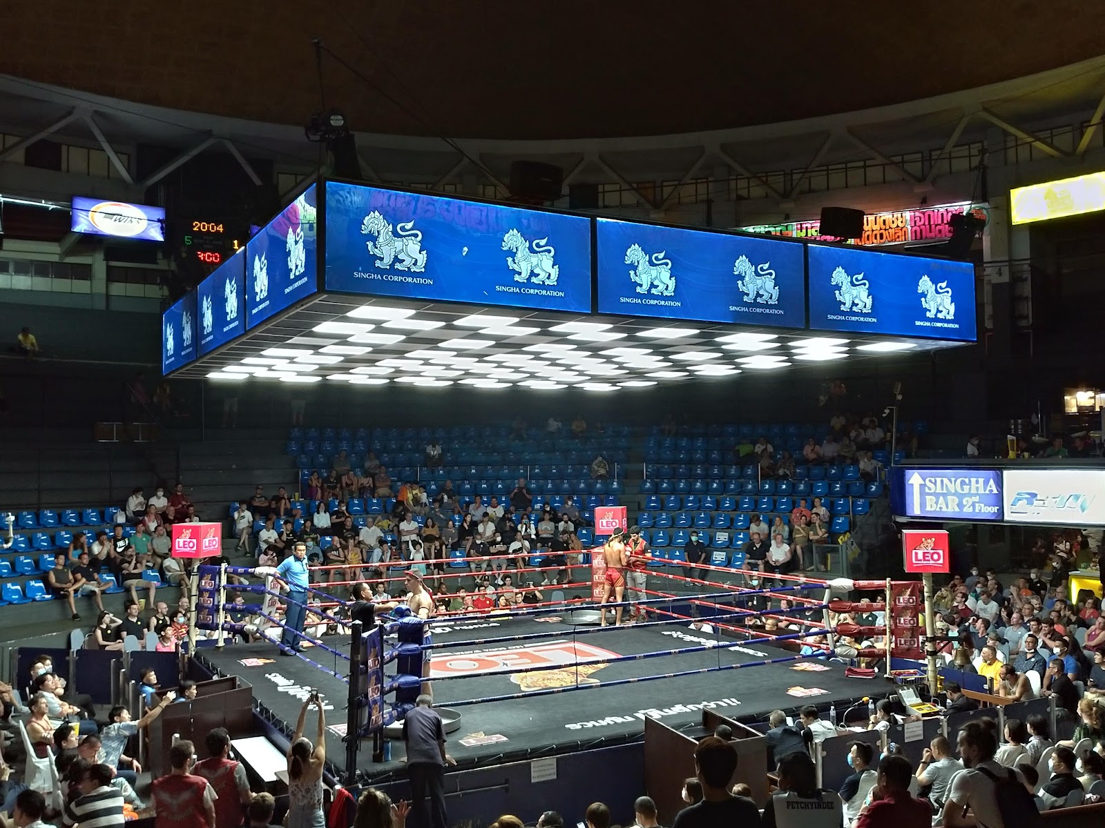 The ring and seating inside Rajadamnern Stadium under stadium lights