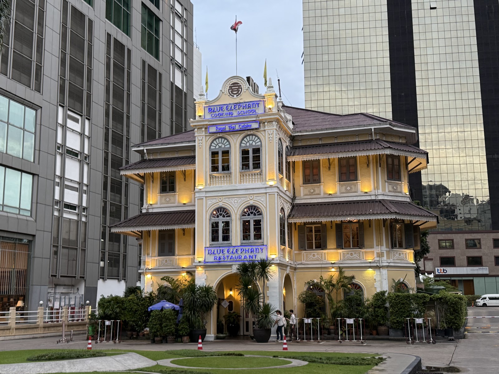 The yellow colonial-style mansion that houses Blue Elephant on South Sathorn Road, with a lawn in front