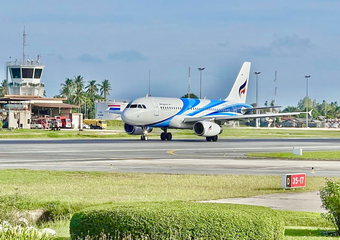 A Bangkok Airways Airbus taxiing past the control tower at Samui Airport