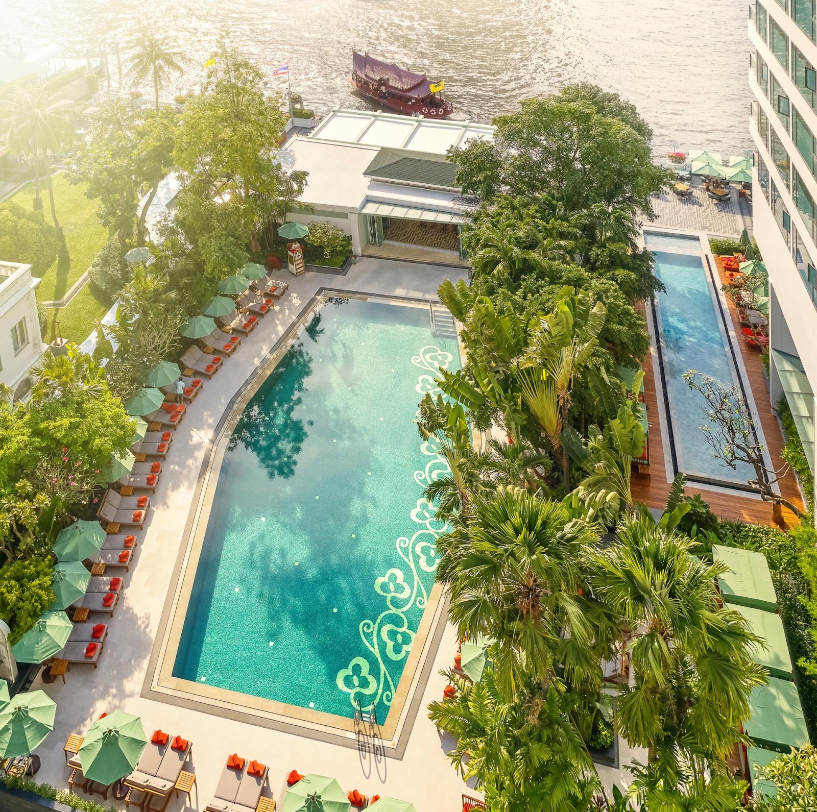 Aerial view of the rectangular outdoor pool among trees beside the Chao Phraya