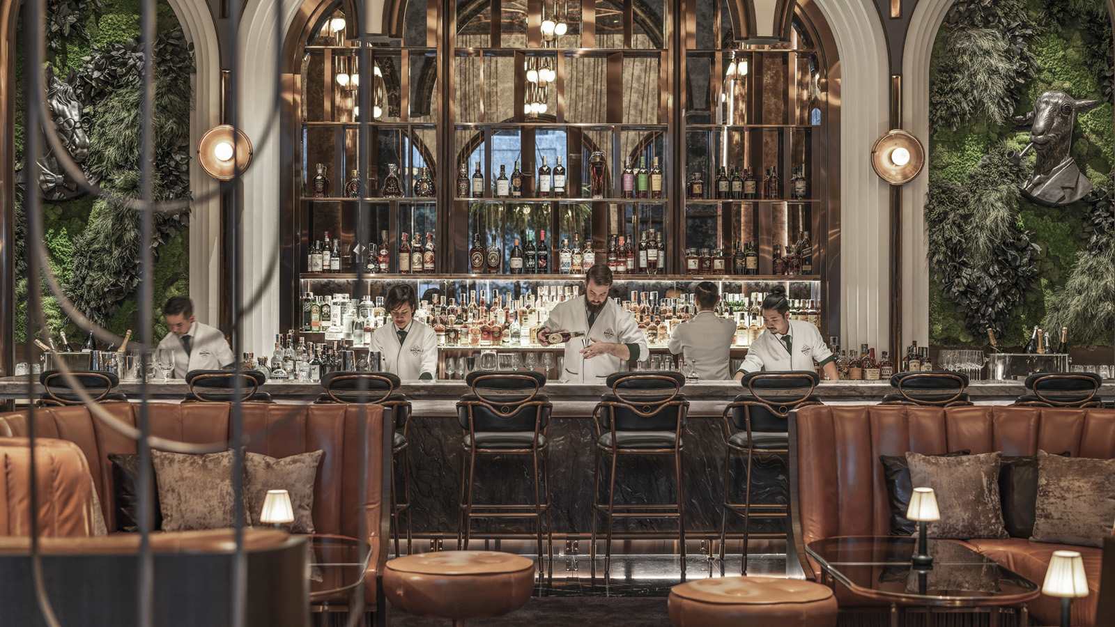 The bar counter and back bar of BKK Social Club under arched windows