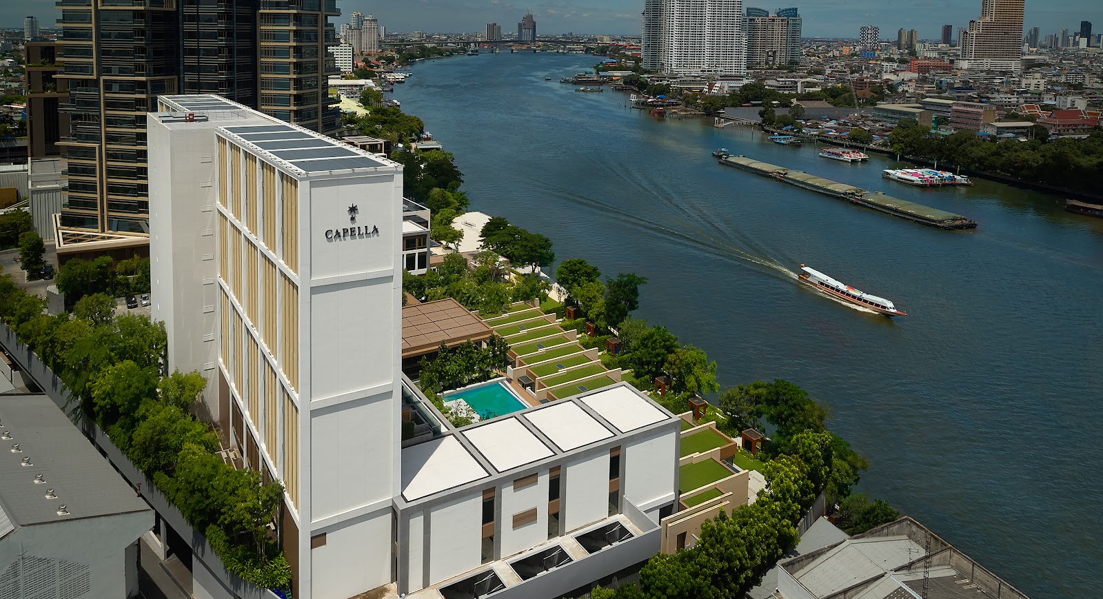 Aerial view of Capella Bangkok's low-rise building and gardens beside the Chao Phraya River