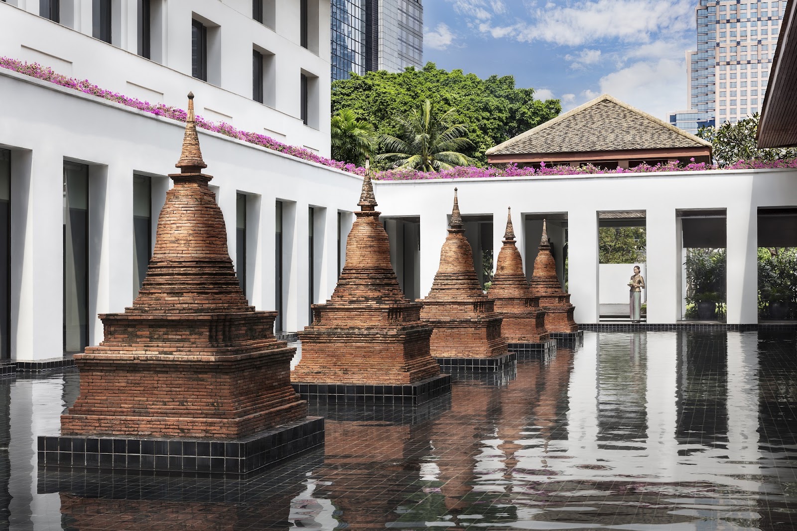 Brick chedis rising from the reflecting pond at The Sukhothai Bangkok