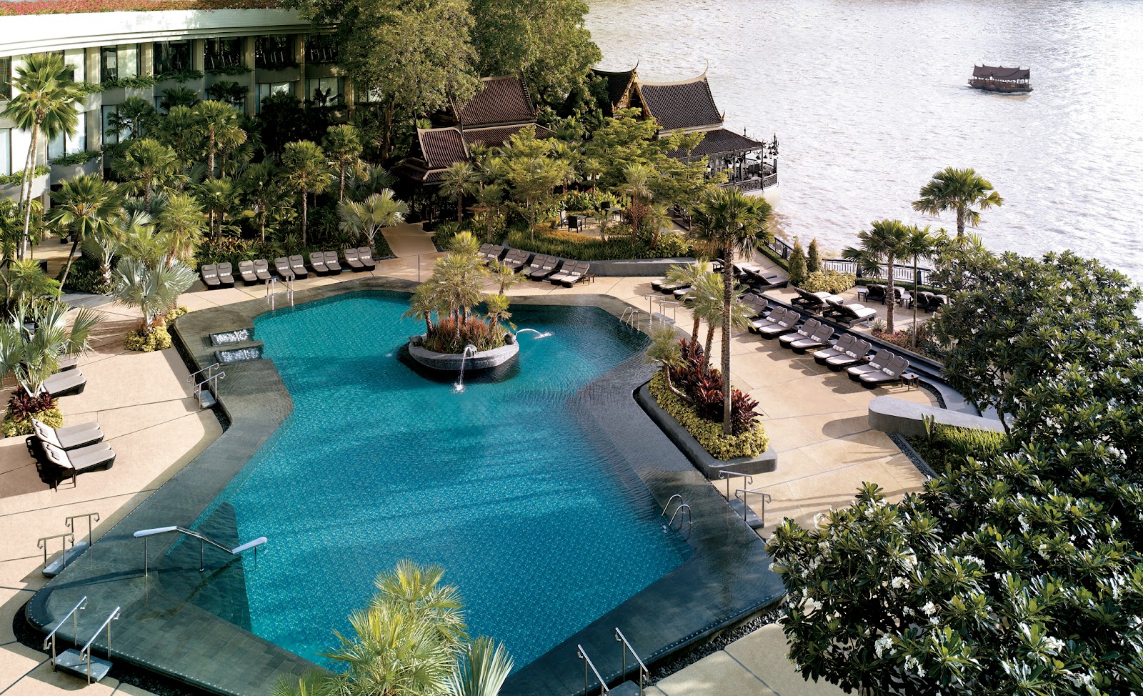 Aerial view of the main pool, gardens and Thai-style pavilions beside the Chao Phraya