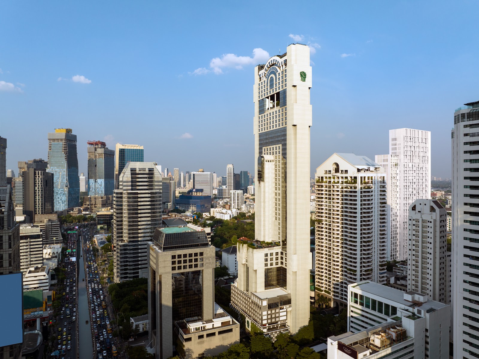Banyan Tree Bangkok's slim white tower rising above the Sathorn skyline on a clear day