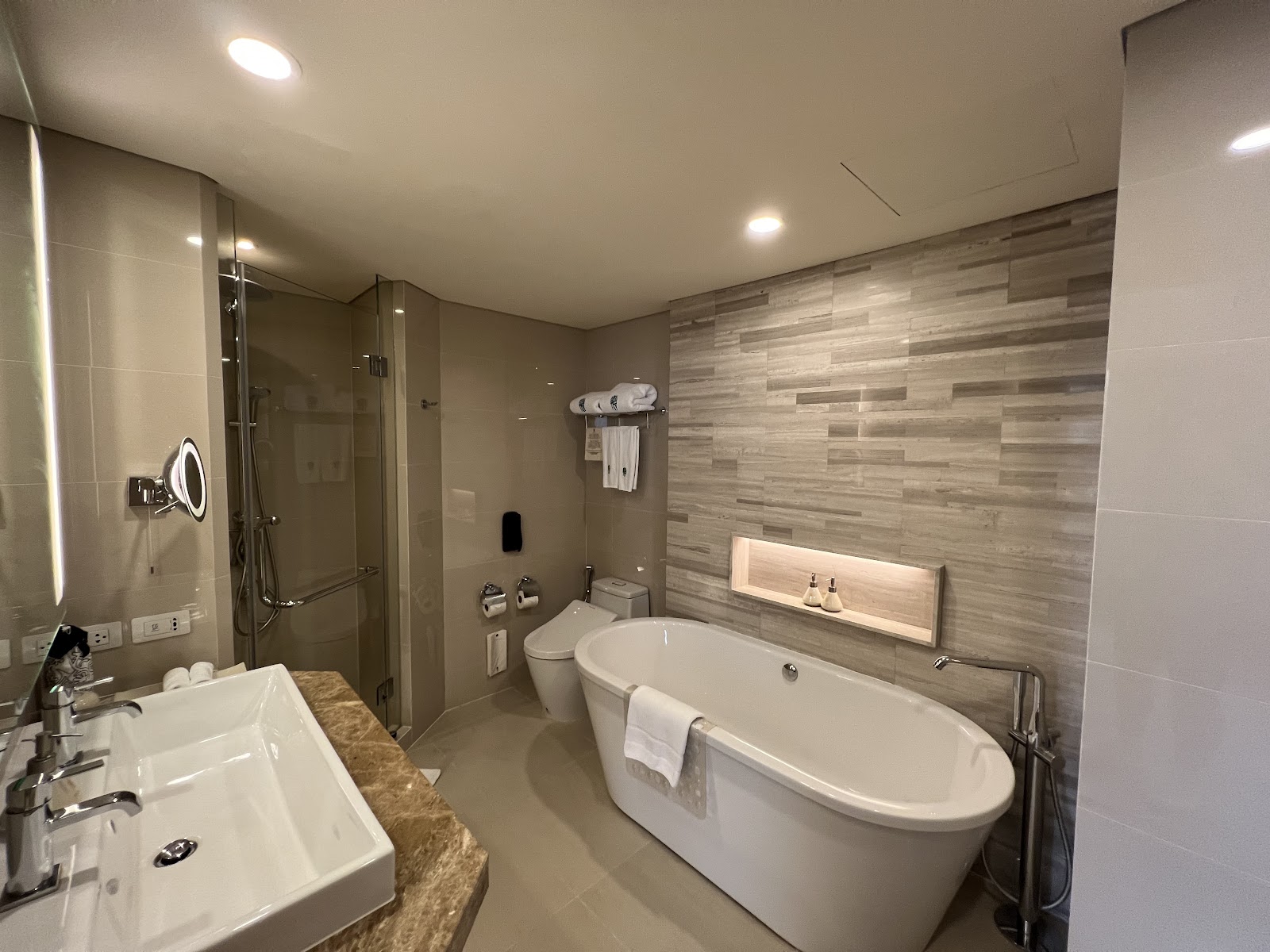 A guest bathroom with a freestanding tub, glass shower and double basin