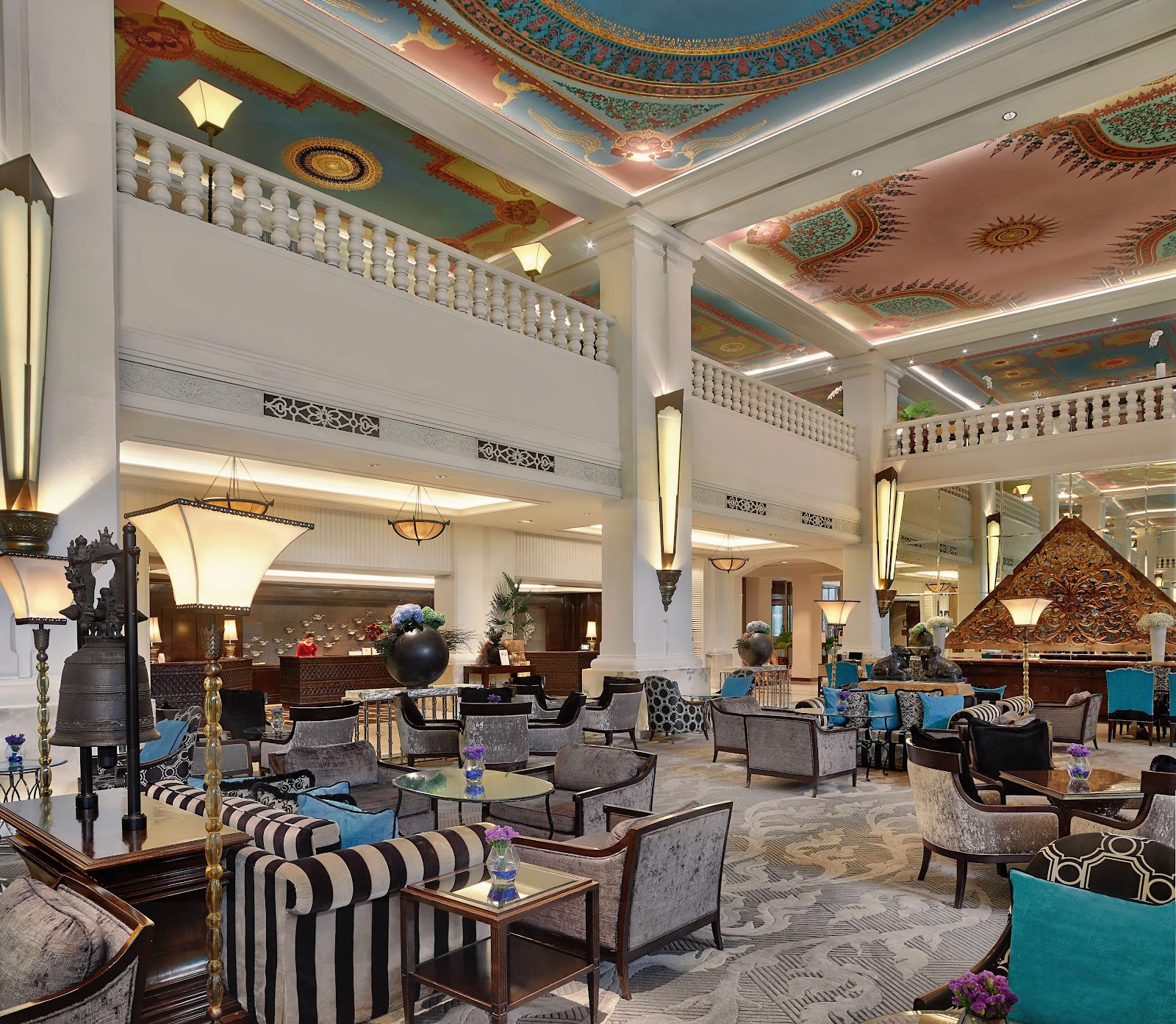The Anantara Siam lobby with its painted ceiling, columns and lounge seating