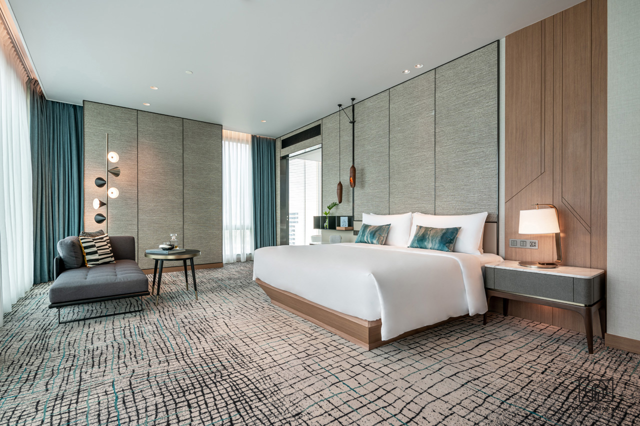 A Kimpton Maa-Lai guest room with a king bed, a daybed and tall windows