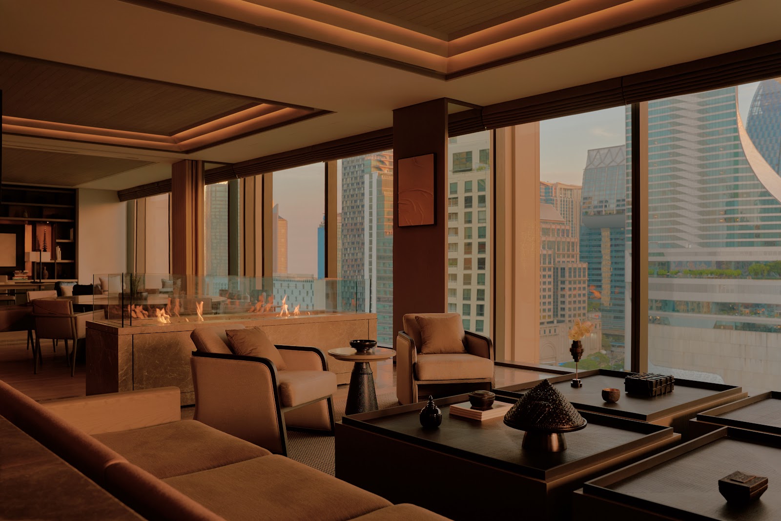 Dark wood lounge with low sofas and floor-to-ceiling windows onto city towers