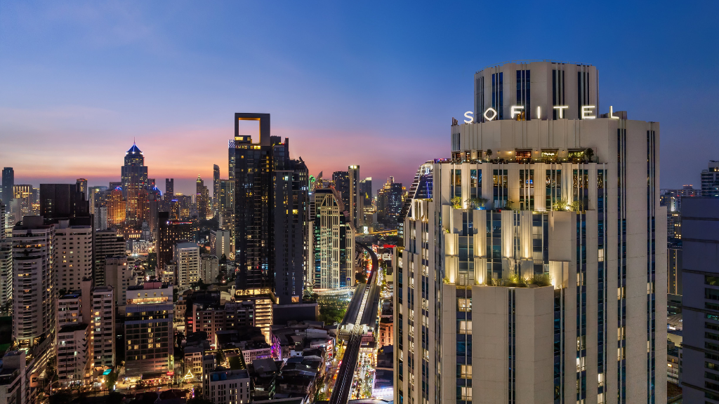 Sofitel Bangkok Sukhumvit tower among the Sukhumvit skyline at dusk