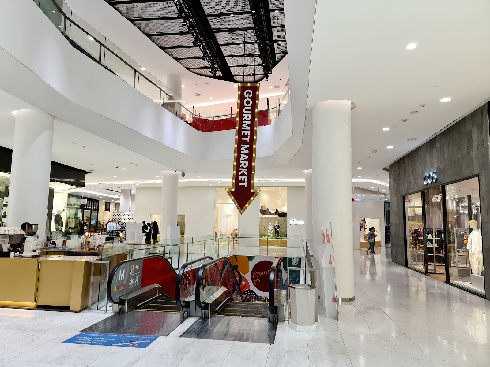 The bright atrium and escalators inside EmQuartier at Phrom Phong