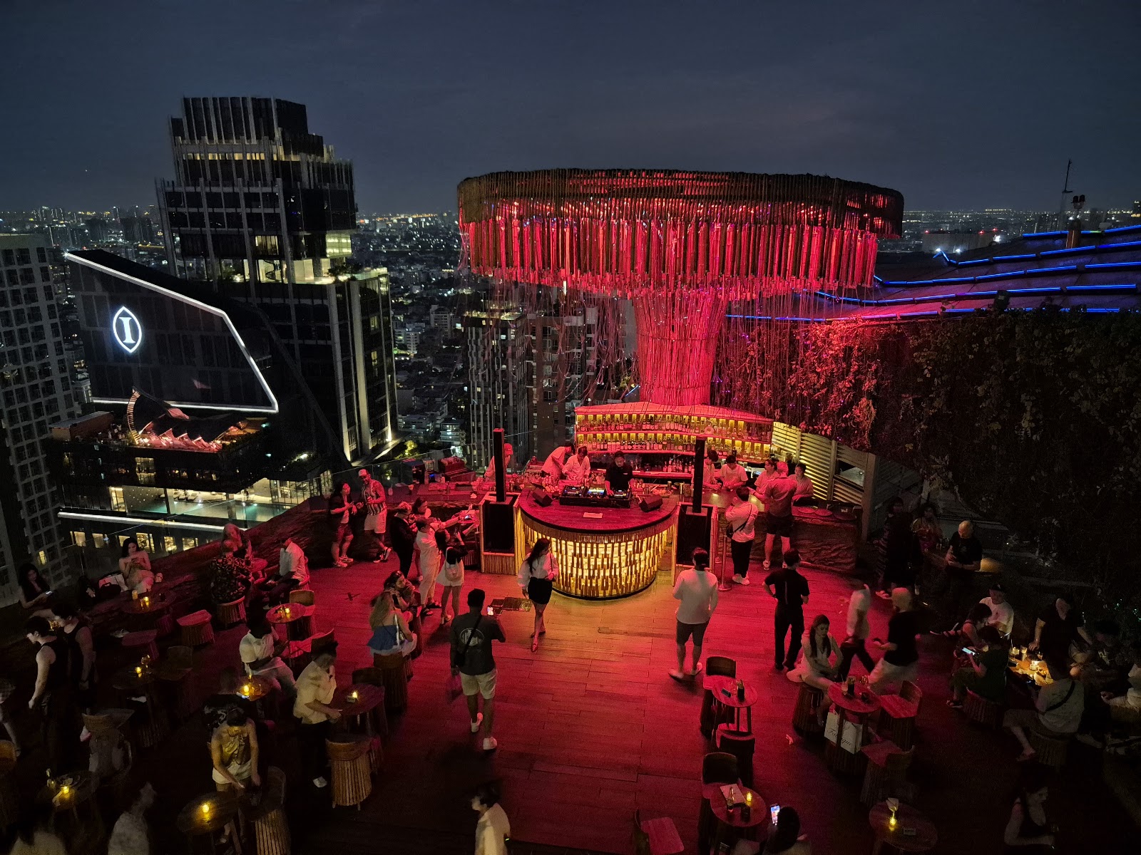 The glowing bamboo tree structure above the Tichuca rooftop terrace at night