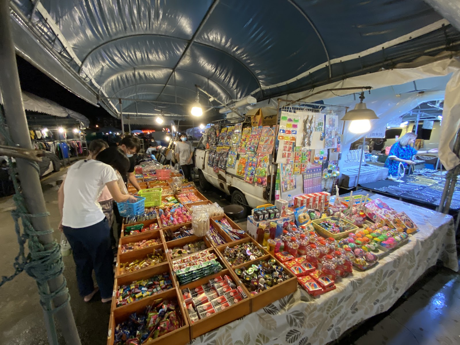 Stalls of small collectibles under a canopy at the Train Night Market Srinagarindra