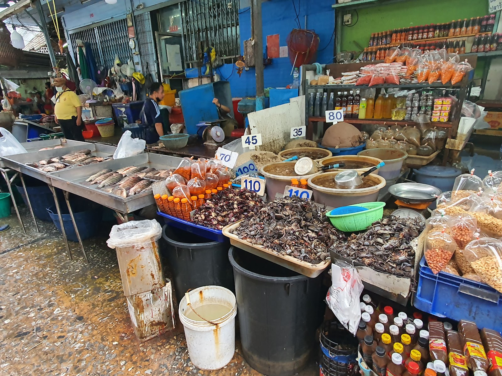 Stalls piled with dried mushrooms, spices and sauces at Khlong Toei Market